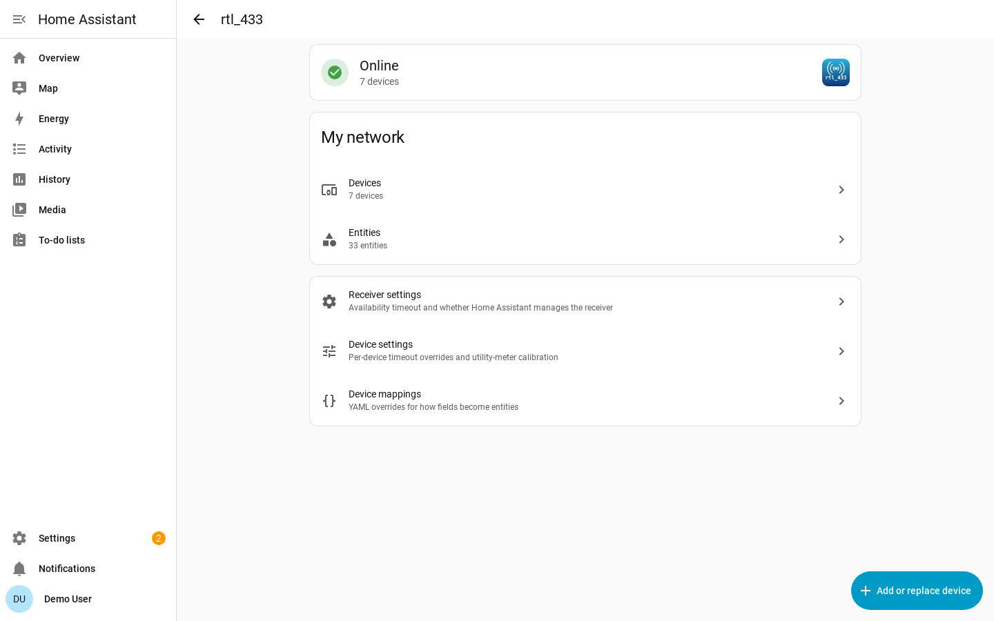 The rtl_433 page: a status card with a green tick reading Online and 7 devices; a My network card listing Devices, 7 devices and Entities, 33 entities, each with a chevron; then a card of three rows — Receiver settings (availability timeout and whether Home Assistant manages the receiver), Device settings (per-device timeout overrides and utility-meter calibration) and Device mappings (YAML overrides for how fields become entities); and a blue Add or replace device button in the bottom right